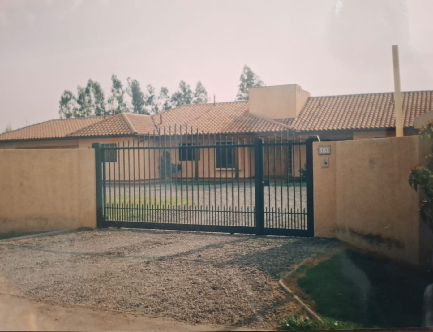 Vivienda de un piso con acceso vehicular enrejado